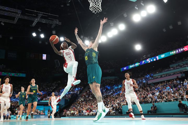 PARIS, FRANCE - AUGUST 09: (EDITORS NOTE: Image was captured using a remote camera) Kahleah Copper #7 of Team United States goes up for a basket over Cayla George #15 of Team Australia during a Women's semifinal match between Team United States and Team Australia on day fourteen of the Olympic Games Paris 2024 at Bercy Arena on August 09, 2024 in Paris, France. (Photo by Gregory Shamus/Getty Images)