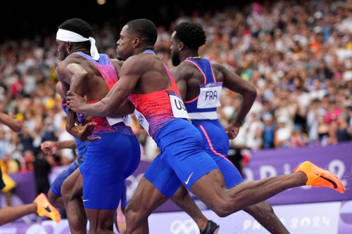 Christian Coleman struggles to hand the baton to teammate Kenny Bednarek in the men's 4x100-meter relay final at the 2024 Summer Olympics on Friday.