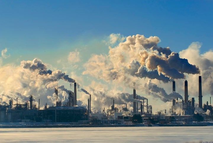 Air pollution rises from smokestacks at a gas and oil refinery on the St. Clair River at Port Huron, Michigan.