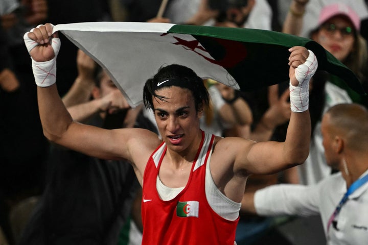 Algeria's Imane Khelif reacts after beating China's Yang Liu (Blue) in the women's 66kg final boxing match during the Paris 2024 Olympic Games at the Roland-Garros Stadium, in Paris on August 9, 2024.
