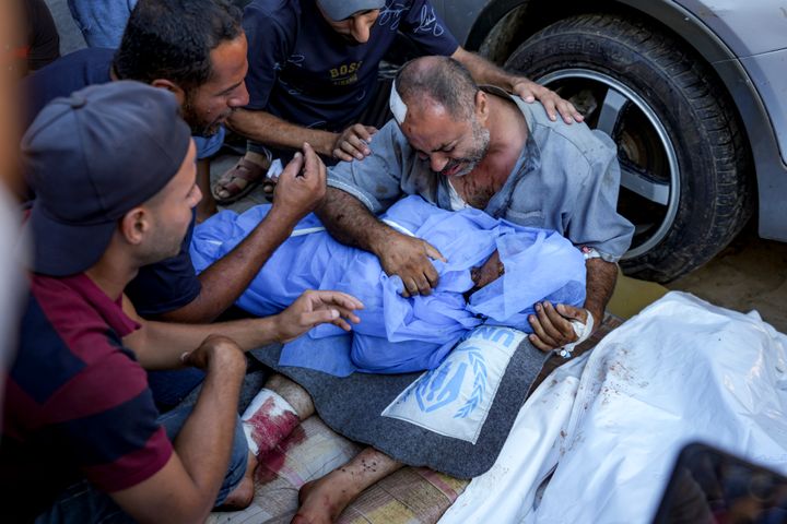 A Palestinian man mourns for a relative killed in the Israeli bombardment of the Gaza Strip, at a hospital in Deir al-Balah, Saturday, Aug. 10, 2024. (AP Photo/Abdel Kareem Hana)