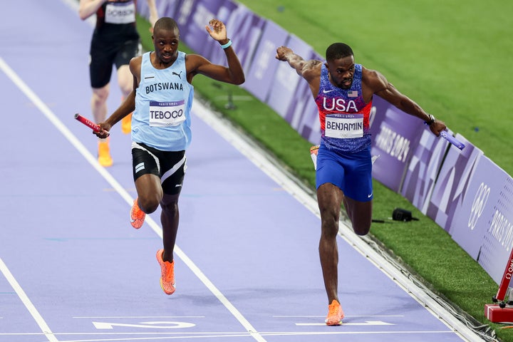 Rai Benjamin of USA and Letsile Tebogo of Botswana lean at the finish of the 4x400 relay at the Paris Olympics.