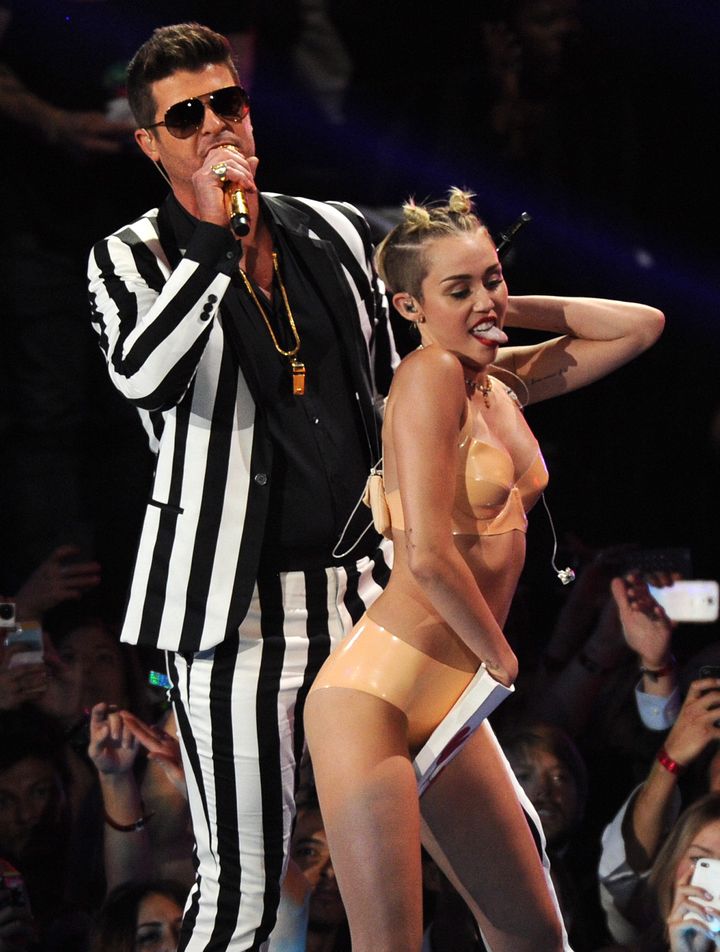 Miley Cyrus and Robin Thicke perform during the 2013 MTV Video Music Awards. While accepting the Disney Legend honor on Sunday, Cyrus said "Sorry, Mickey" for her rebellious era.