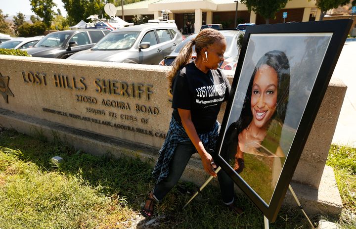 Mental health worker Kim Howard places a photo of Mitrice Richardson at the Lost Hills Sheriff Station in Calabasas for a memorial and press conference on the 10th anniversary of her disappearance following her release from the Malibu-Lost Hills Sheriff's station in 2009 and whose body was found in August 2010.