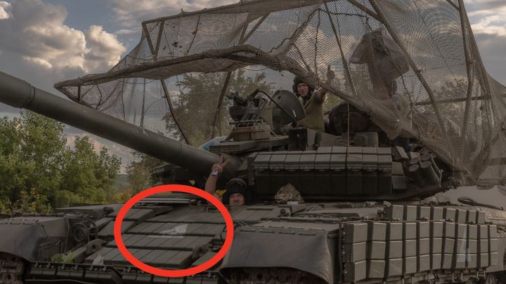 A white triangle emblazoned on the front of a Ukrainian tank