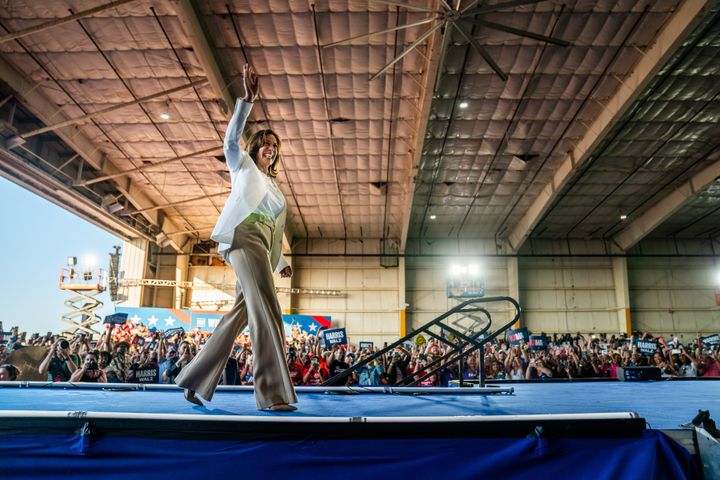 Vice President Kamala Harris waves to the crowd at Signature Aviation Hangar in Detroit on Aug. 7, 2024. Harris' campaign said 15,000 people attended the rally. 