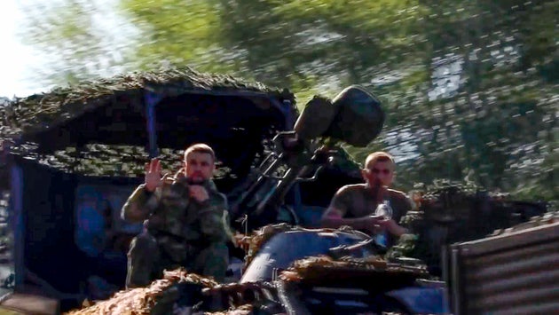 Soldiers sit in a military truck as a column of the Russian Armed Forces move to build up forces conducting active combat operations with Ukrainian formations in the Sudzhansky district of Kursk region of Russia.