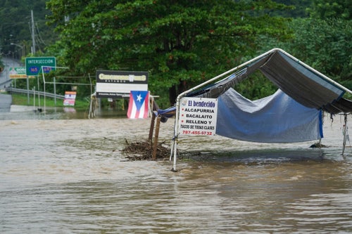 Flash flooding covers a roadway after Tropical Storm Ernesto moved through Dorado, Puerto Rico, on Aug. 14, 2024. Ernesto grew into a hurricane on Wednesday.