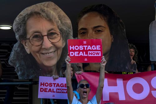 Relatives and supporters of Israeli hostages held by Hamas in Gaza hold photos of their loved ones during a protest calling for their return in Tel Aviv, Israel, on Aug. 15, 2024.