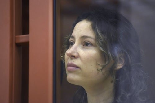 Ksenia Karelina, also known as Khavana sits in a glass cage in a court room in Yekaterinburg, Russia, on Aug. 15, 2024. 
