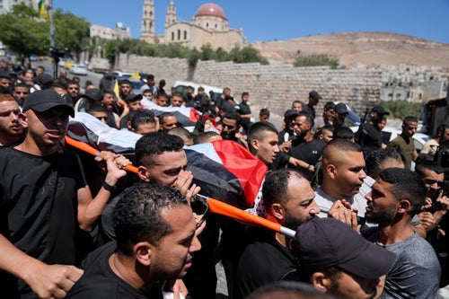 Mourners carry the bodies of Palestinians Wael Misha, 18, front, and Ahmed Sheikh Khalil, 20, both killed by an airstrike overnight during an army operation in the occupied West Bank, during their funeral in the refugee Camp of Balata, in Nablus, on Aug. 15, 2024. 