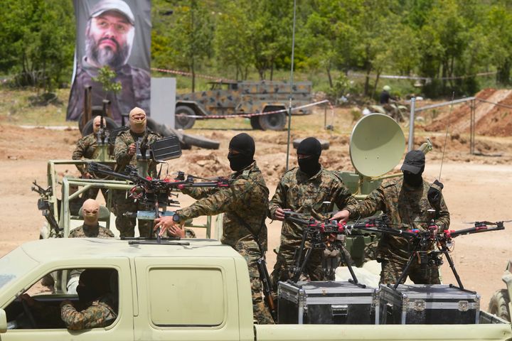 FILE - Hezbollah militants take part in a military exercise with armed drones in Aaramta village in the Jezzine District, southern Lebanon, on May 21, 2023. (AP Photo/Hassan Ammar, File)