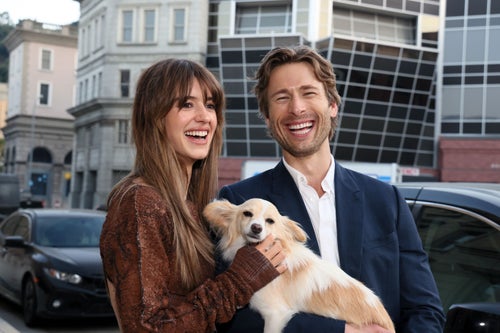 “Twisters” co-stars Daisy Edgar-Jones, left, and Glen Powell pose with Powell’s dog, Brisket.