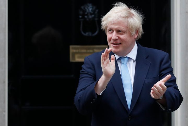 Former PM Boris Johnson stands outside 10 Downing Street to join in the nationwide Clap for Carers to recognise and support National Health Service (NHS) workers and carers fighting the coronavirus pandemic, in London, Thursday, May 21, 2020. 