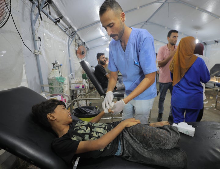 The wounded, including children, are taken to Al-Awda Hospital in Nuseirat Camp for treatment after the Israeli army attacked the house of the al-Saidy family in the central Gaza Strip on Aug. 18.