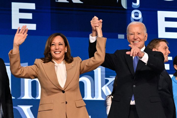 President Joe Biden holds hands Monday night with Vice President Kamala Harris, the Democratic presidential nominee, after he delivering the keynote address on the first day of the Democratic National Convention in Chicago.