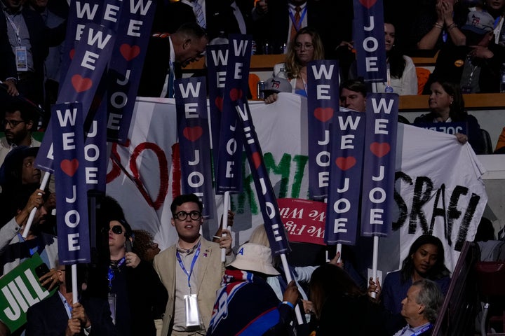 A protest banner is partially obscured during President Joe Biden's speech at the Democratic National Convention in Chicago on Monday.