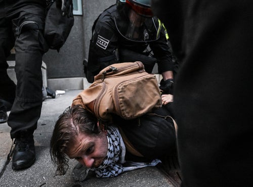 Police officers detain a demonstrator as they intervene against the protestors reacting to the humanitarian crisis in Gaza gathered in front of the Israeli consulate in Chicago, United States where the Democratic Party Congress was held on Aug. 20, 2024. The police intervened the demonstrators harshly, dragged many demonstrators on the ground and detained many demonstrators.
