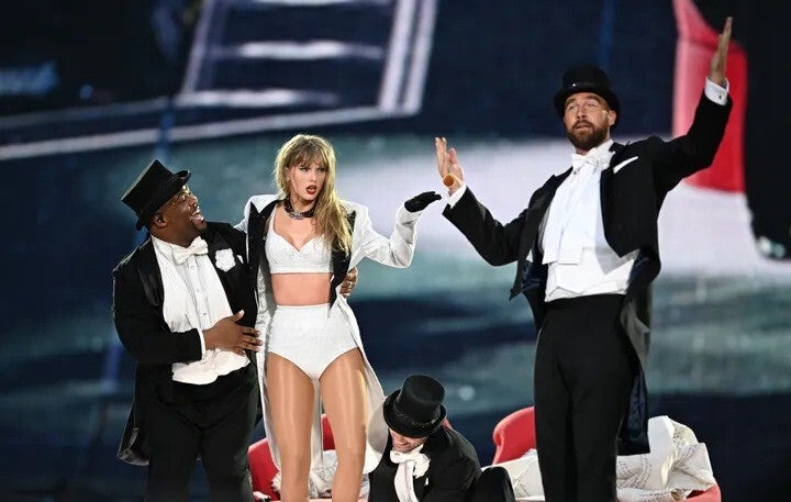 inger Taylor Swift, center, is joined onstage by boyfriend Travis Kelce, right, during an Eras Tour stop at Wembley Stadium on June 23, 2024, in London, England.