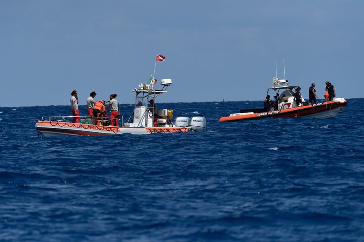 Scuba divers of the Italian Firefighters corp at the scene of the search for a missing boat, in Porticello, southern Italy, Wednesday, Aug. 21, 2024. (AP Photo/Salvatore Cavalli)