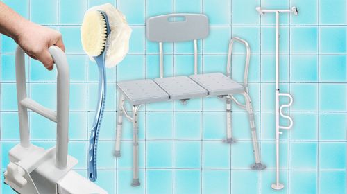 A shower transfer bench, a grab bar, a long-handled body brush and a tension-mounted grab pole.