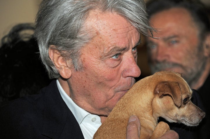 Alain Delon with a dog named Molly at a Christmas display at the Gut Aiderbichl animal sanctuary near Salzburg, Austria, in 2014.