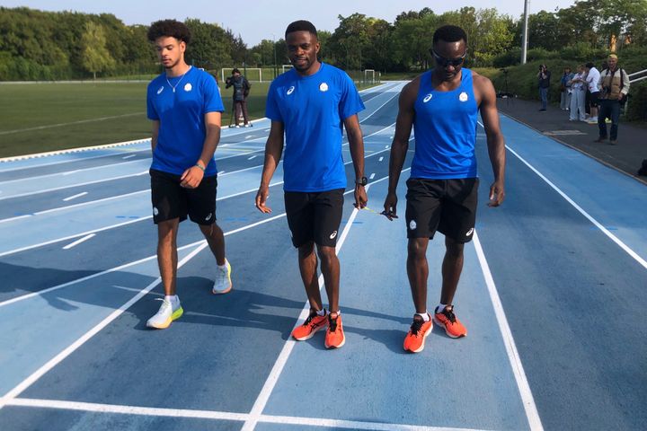 Donard Ndim Nyamjua, center, guide for sprinter Guillaume Junior Atangana, right, a member of the Refugee Paralympic Team, arrive for a training session at the training camp, ahead of the Paralympic Games, Monday, Aug. 19, 2024 in Reims, eastern France. (AP Photo/Patrick Hermansen)