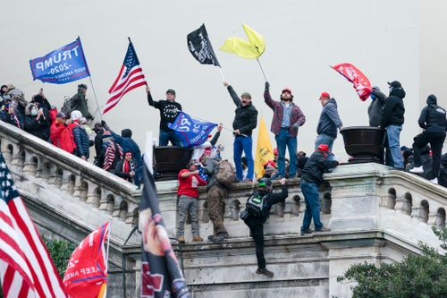 Trump supporters wave flags on the West Front of the U.S. Capitol in Washington on Jan. 6, 2021. 