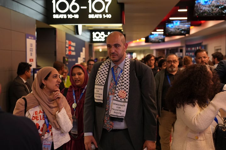 Abbas Alawieh (right), co-founder of the "uncommitted" movement, walks the halls Tuesday at the Democratic National Convention in Chicago.