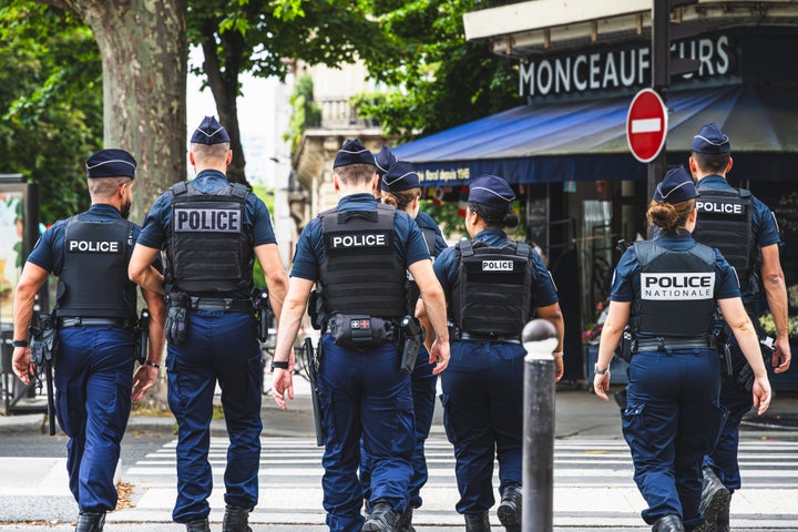 Uniformed police officers patrol on foot and provide security on the streets of Paris, France. July 15, 2024