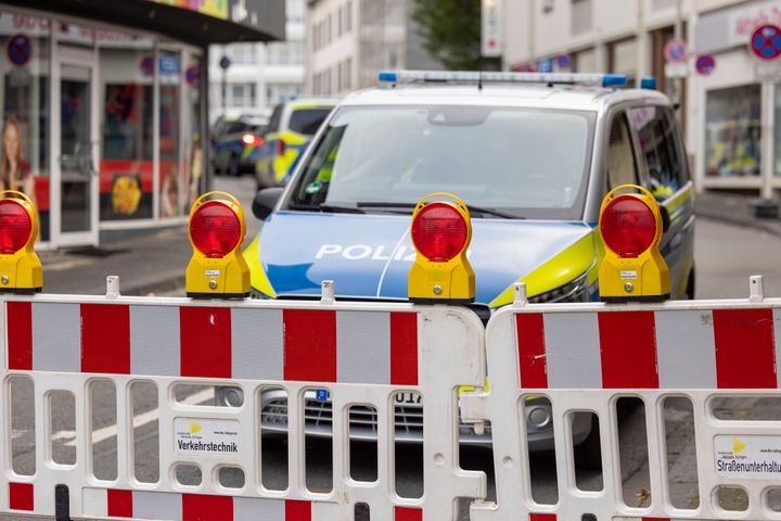 Police emergency vehicles stand at a cordon in the city center of Solingen, Germany, in the early morning of Sunday, Aug. 25, 2024, following Friday's deadly attack at the city's 650th anniversary celebrations. (Thomas Banneyer/dpa via AP)