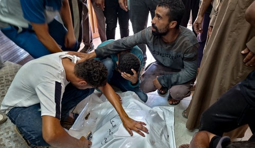 Palestinians mourn a relative killed in the Israeli bombardment of the Gaza Strip, at a hospital in Khan Younis on Aug. 24, 2024.
