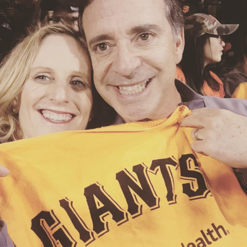 The author and Dave at a San Francisco Giants playoff game."We loved going to see the Giants and Warriors play," she writes.
