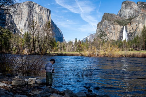 A 4-year-old boy stands along the Merced River inside the Yosemite National Park in California. The money will be used to address the needs of the country's more than 400 national park sites.