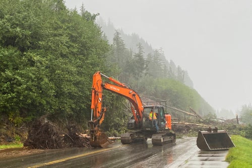 A worker clears debris after the deadly landslide on Sunday.