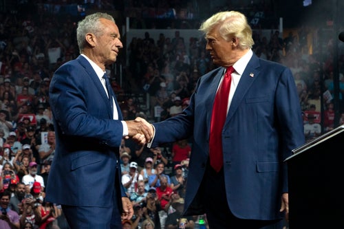Robert F. Kennedy Jr. greets Donald Trump in Glendale, Arizona, on Friday. Kennedy said he dropped out of the presidential race to avoid handing the election to Vice President Kamala Harris.