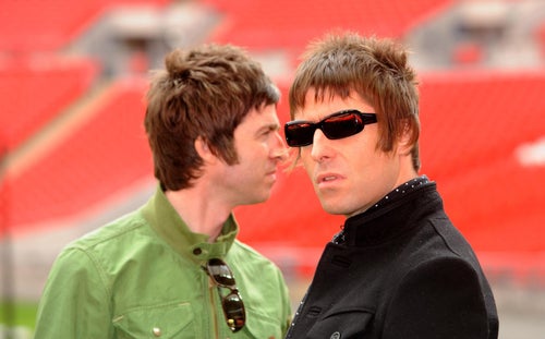 Oasis band members Noel Gallagher and Liam Gallagher at a photoshoot at Wembley Stadium, London, before the band broke up in 2009.