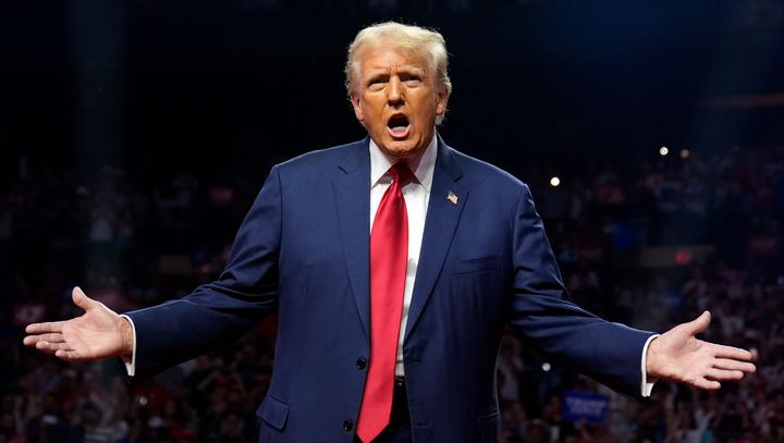 Republican presidential nominee former President Donald Trump gestures at a campaign rally at the Desert Diamond Arena, Friday, Aug. 23, 2024.