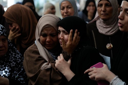 Mourners cry during the funeral of five Palestinians who were killed by an Israeli military airstrike in the northern occupied West Bank, in the refugee camp of Nur Shams, Tulkarem, on Aug. 27, 2024.