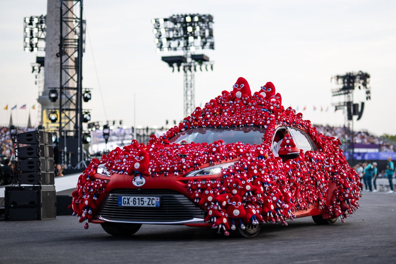 French Paralympic Swimmer Theo Curin traveled in a car decorated with the 2024 mascot, the Phryge.