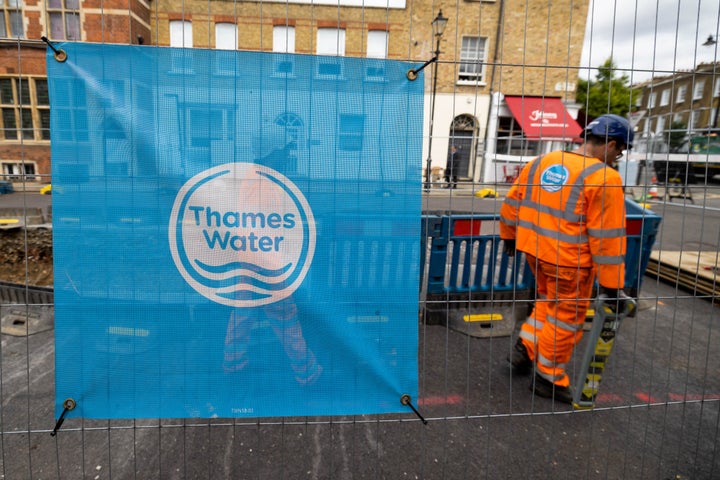 A sign displaying the Thames Water Ltd. company logo on protective barriers surrounding water supply works in London, UK, on Monday, July 8, 2024.