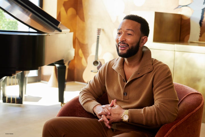 John Legend sits in his family home.