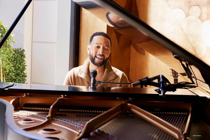 John Legend playing his piano at his family home.