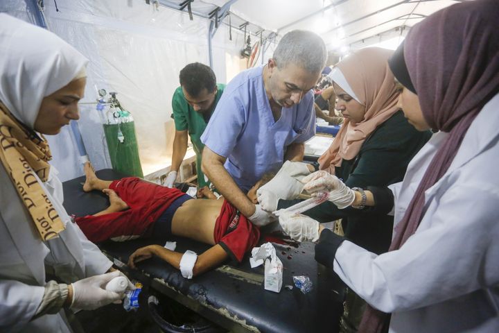 Medical workers are seen in Deir al-Balah, Gaza, on Tuesday, Aug. 27, 2024. Health care personnel in the besieged enclave are struggling to continue to support its population.