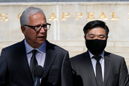 Attorney David Sanford, left, standing with Young Lee, right, brother of murder victim Hae Min Lee, talks with reporters outside Maryland's Supreme Court in Annapolis, Md., Thursday, Oct. 5, 2023. (AP Photo/Susan Walsh)