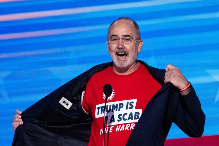 Shawn Fain, president of the United Automobile Workers, shows off his "Trump is a scab" T-shirt during the 2024 Democratic National Convention in Chicago on Aug. 19, 2024.