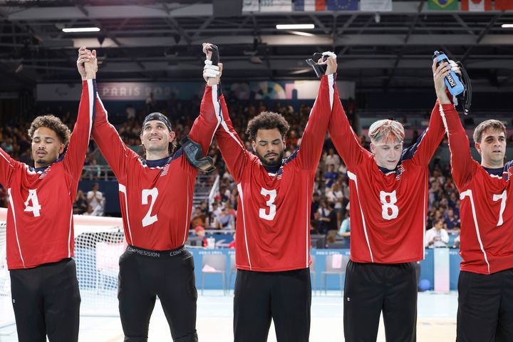 From left, U.S. team goalball players Tre'shaun Faison, Tyler Merren, Zion Walker, Christian King and Matt Simpson raise their hands after a 5-4 victory over the French men's goalball team during the Paralympic Games in Paris, Saturday, Aug. 31, 2024.