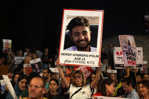 Relatives and supporters raise placards bearing portraits of Israeli hostage Hersh Goldberg-Polin, 23, and other hostages held in Gaza since the October 7 attacks by Hamas in southern Israel, during a rally calling for their release, outside the PM's office in Jerusalem on May 22, 2024. (Photo by AHMAD GHARABLI / AFP) (Photo by AHMAD GHARABLI/AFP via Getty Images)