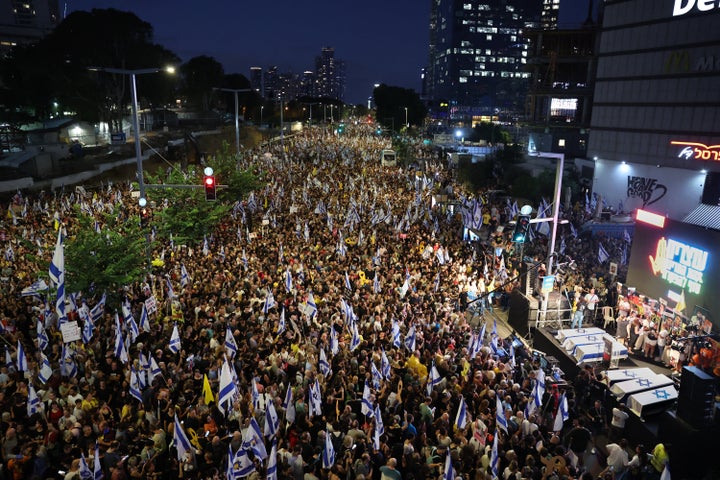 Protesters lift Israeli flags and placards around symbolic coffins representing the six hostages whose bodies were recovered from the Gaza Strip, during an anti-government rally calling for the release of the Hamas captives held since October.