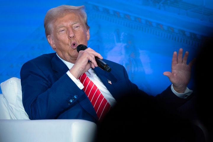 Republican presidential nominee former President Donald Trump speaks with Moms for Liberty co-founder Tiffany Justice during an event at the group's annual convention in Washington, Friday, Aug. 30, 2024. 